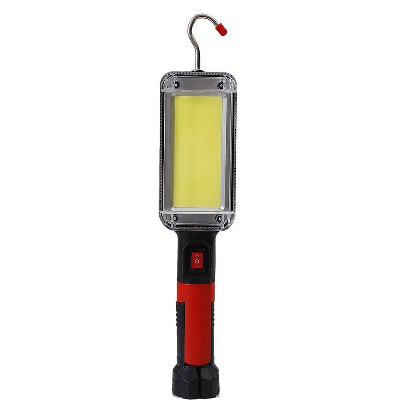 Red portable COB LED flashlight with a magnetic hook on a metal surface.