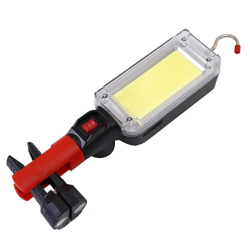 Red portable COB LED flashlight with a magnetic hook on a metal surface.