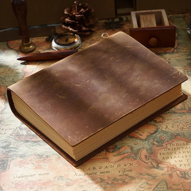 Handmade leather notebook with brown Crazy Horse cover, 200 pages, 19x14cm, open on a desk