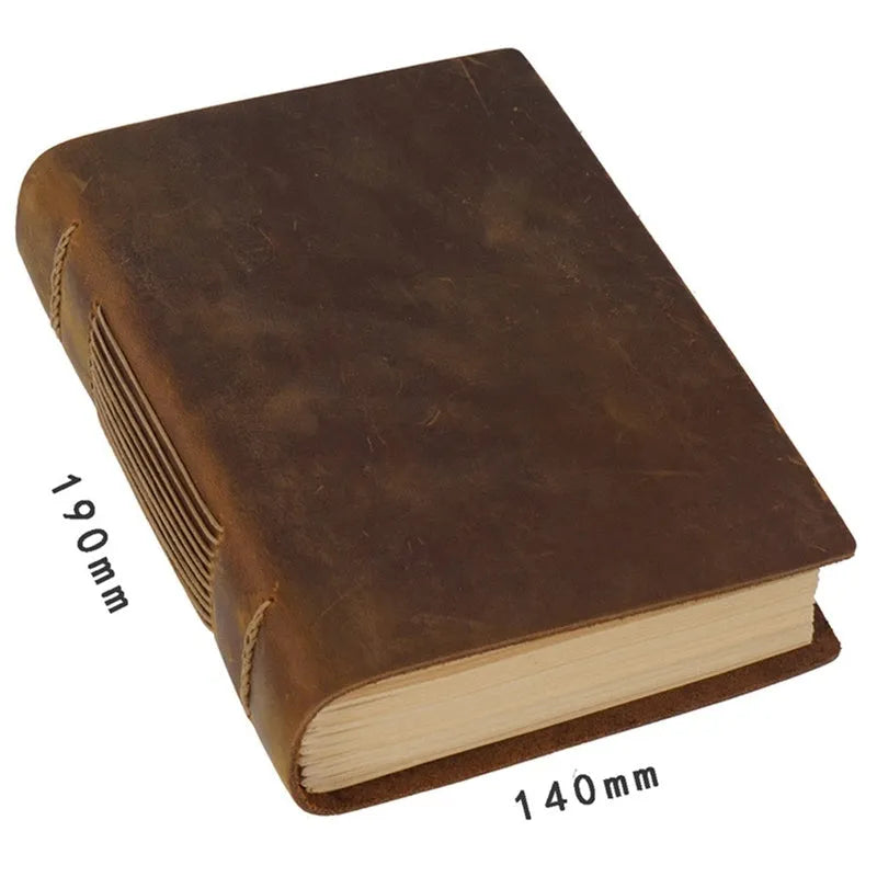 Handmade leather notebook with brown Crazy Horse cover, 200 pages, 19x14cm, open on a desk