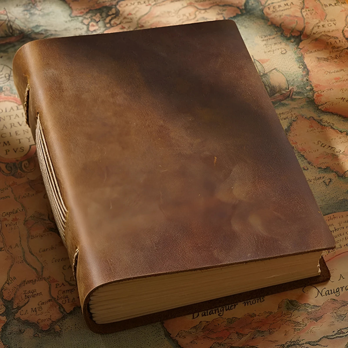 Handmade leather notebook with brown Crazy Horse cover, 200 pages, 19x14cm, open on a desk