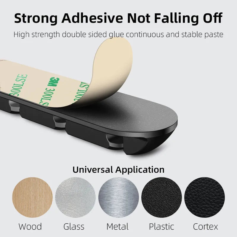 Black soft plastic desktop charging stand with adhesive base for organising cables.