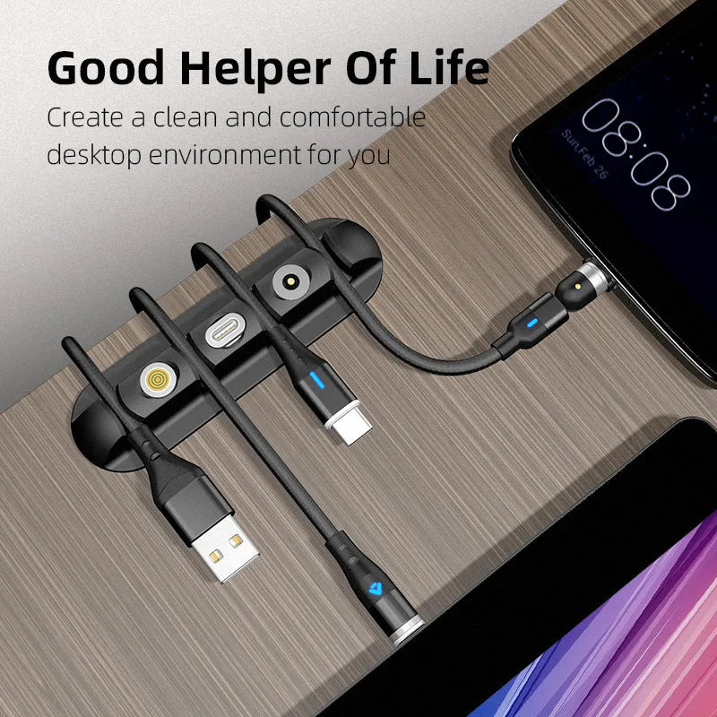 Black soft plastic desktop charging stand with adhesive base for organising cables.
