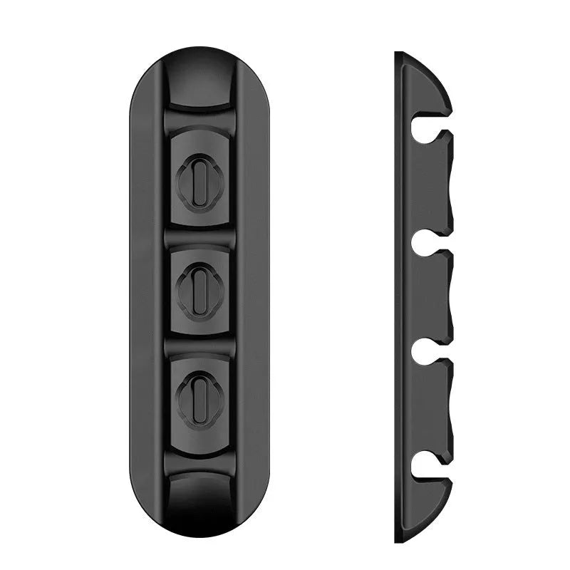 Black soft plastic desktop charging stand with adhesive base for organising cables.