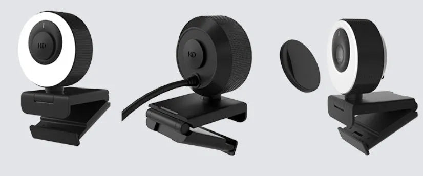Black USB webcam with magnetic privacy cover on computer monitor
