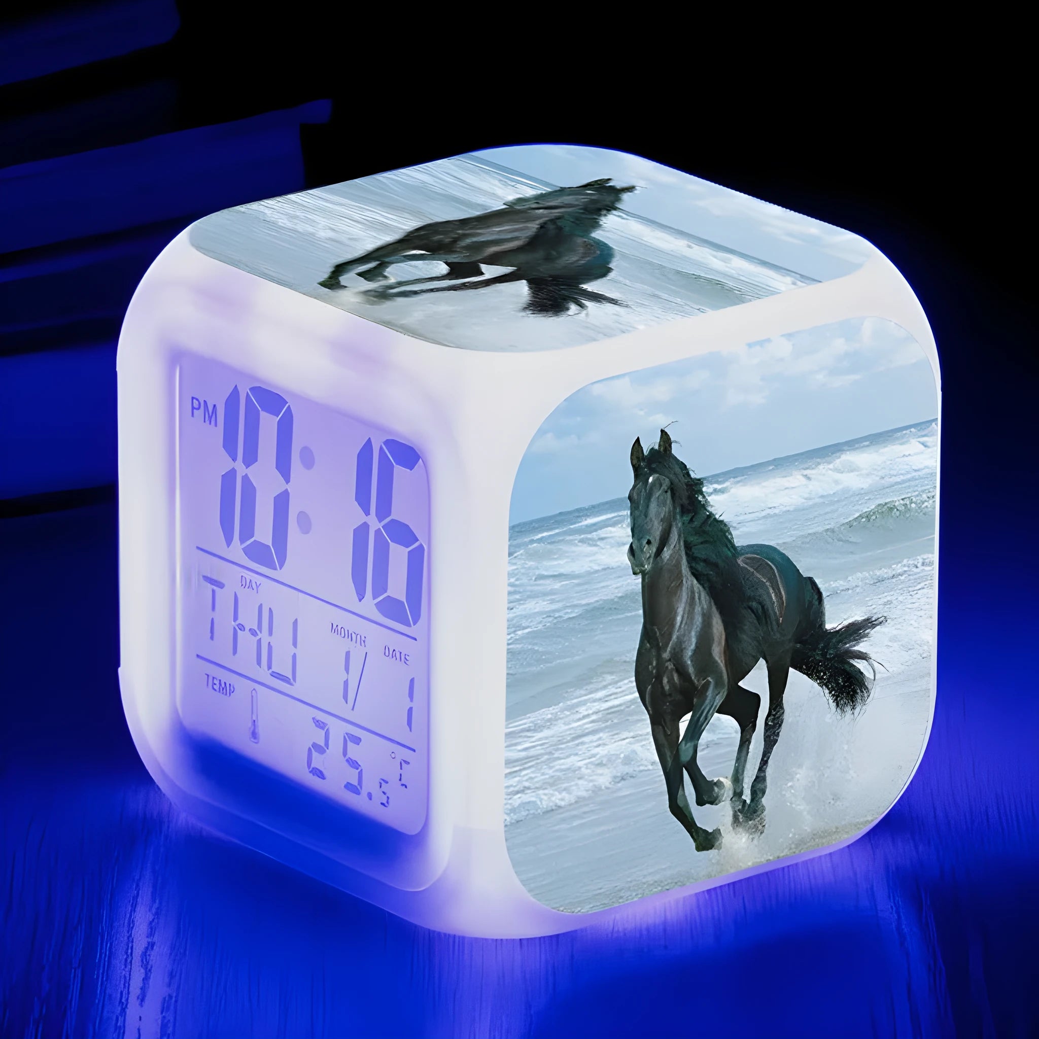 Small square cartoon-style LED alarm clock showing digital time and temperature on a colourful display.