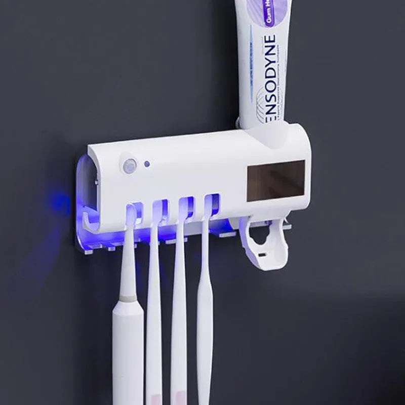 Black wall-mounted toothbrush steriliser with UV light and integrated toothpaste squeezer.