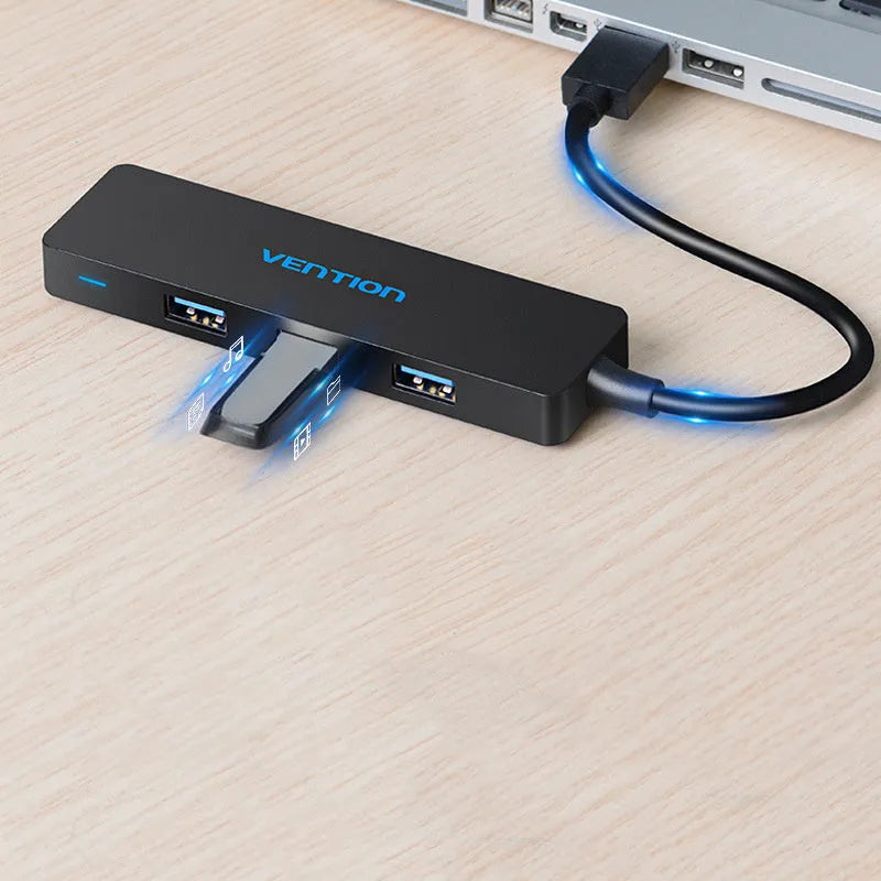 Black USB 3.0 hub with 4 ports and 15cm shielded cable connecting to computer