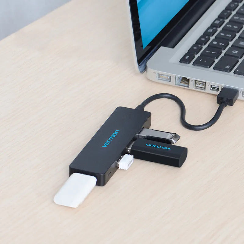 Black USB 3.0 hub with 4 ports and 15cm shielded cable connecting to computer