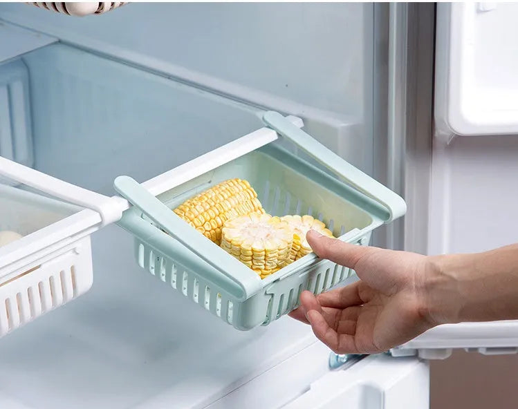 Telescopic plastic refrigerator storage basket in blue colour organising fruits and vegetables in drawer