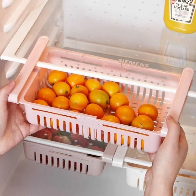 Telescopic plastic refrigerator storage basket in blue colour organising fruits and vegetables in drawer