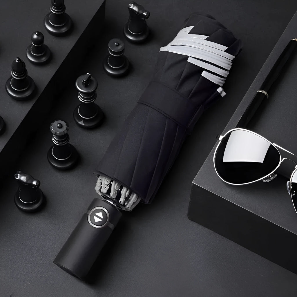 Black automatic reverse folding car umbrella showing inverted closure mechanism and plastic non-slip handle.