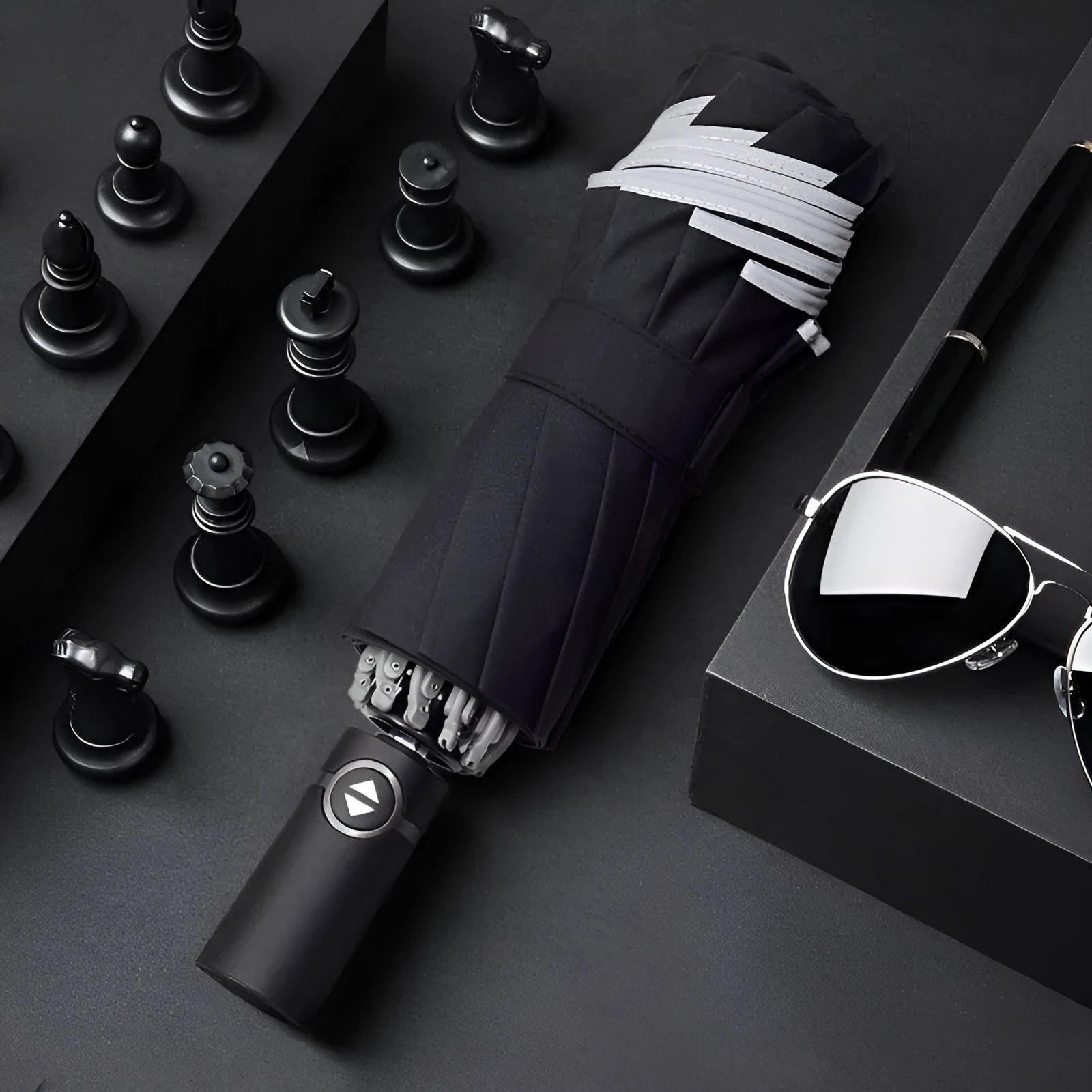 Black automatic reverse folding car umbrella showing inverted closure mechanism and plastic non-slip handle.
