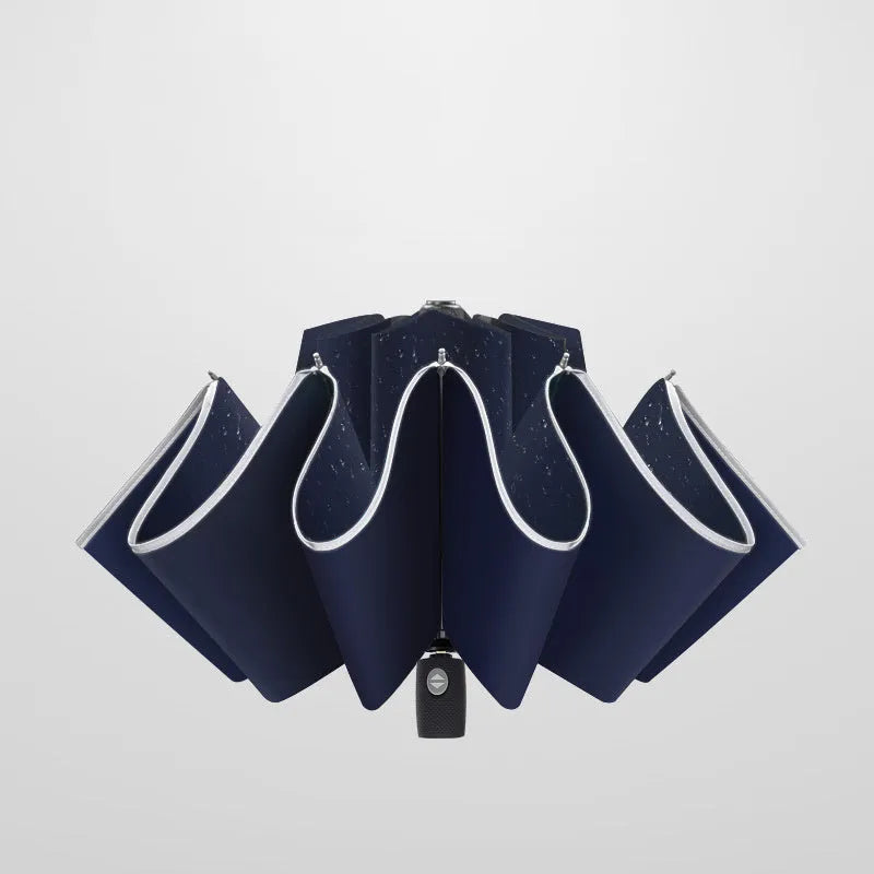 Black automatic reverse folding car umbrella showing inverted closure mechanism and plastic non-slip handle.