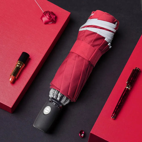 Automatic reverse umbrella with black canopy showing three-fold design and plastic non-slip handle