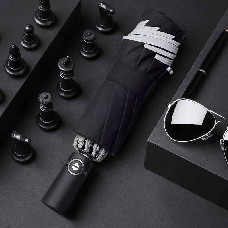 Black automatic reverse folding car umbrella showing inverted closure mechanism and plastic non-slip handle.