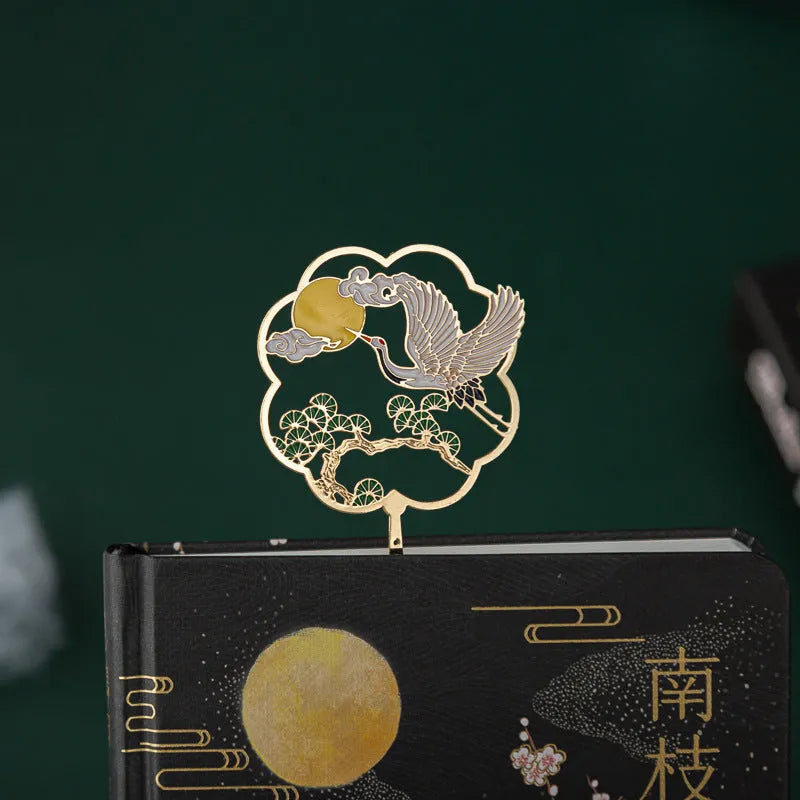 Chinese style feather pen set with metal sheaths in four colours alongside a Jianhegui notebook.