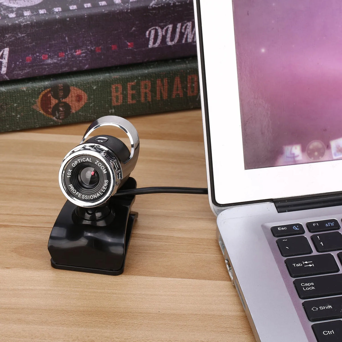 Black notebook HD USB computer camera with manual focus lens and built-in microphone on a monitor