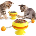 Rotatable suction cup cat toy with transparent top showing three catnip balls, in lake blue colour.