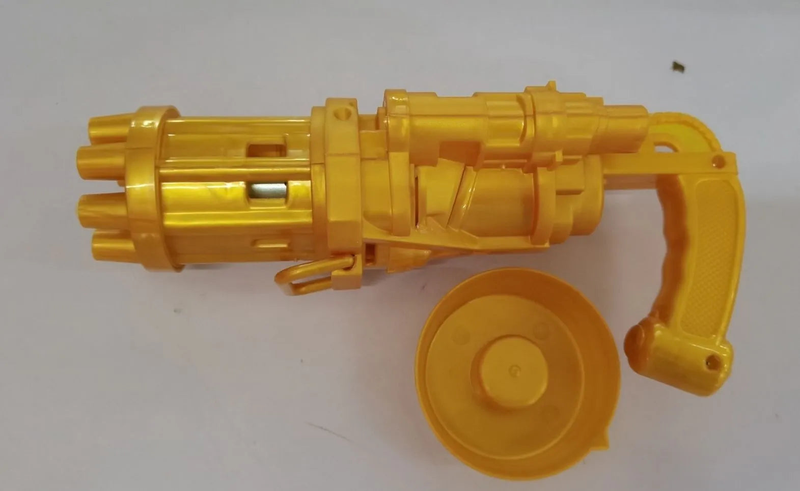 Kids bubble machine gun toy in pink, gold, or black colours with battery compartment and bubble solution