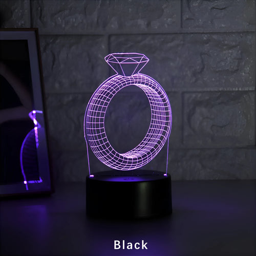 3D diamond ring design LED night light with colour-changing light on black background.