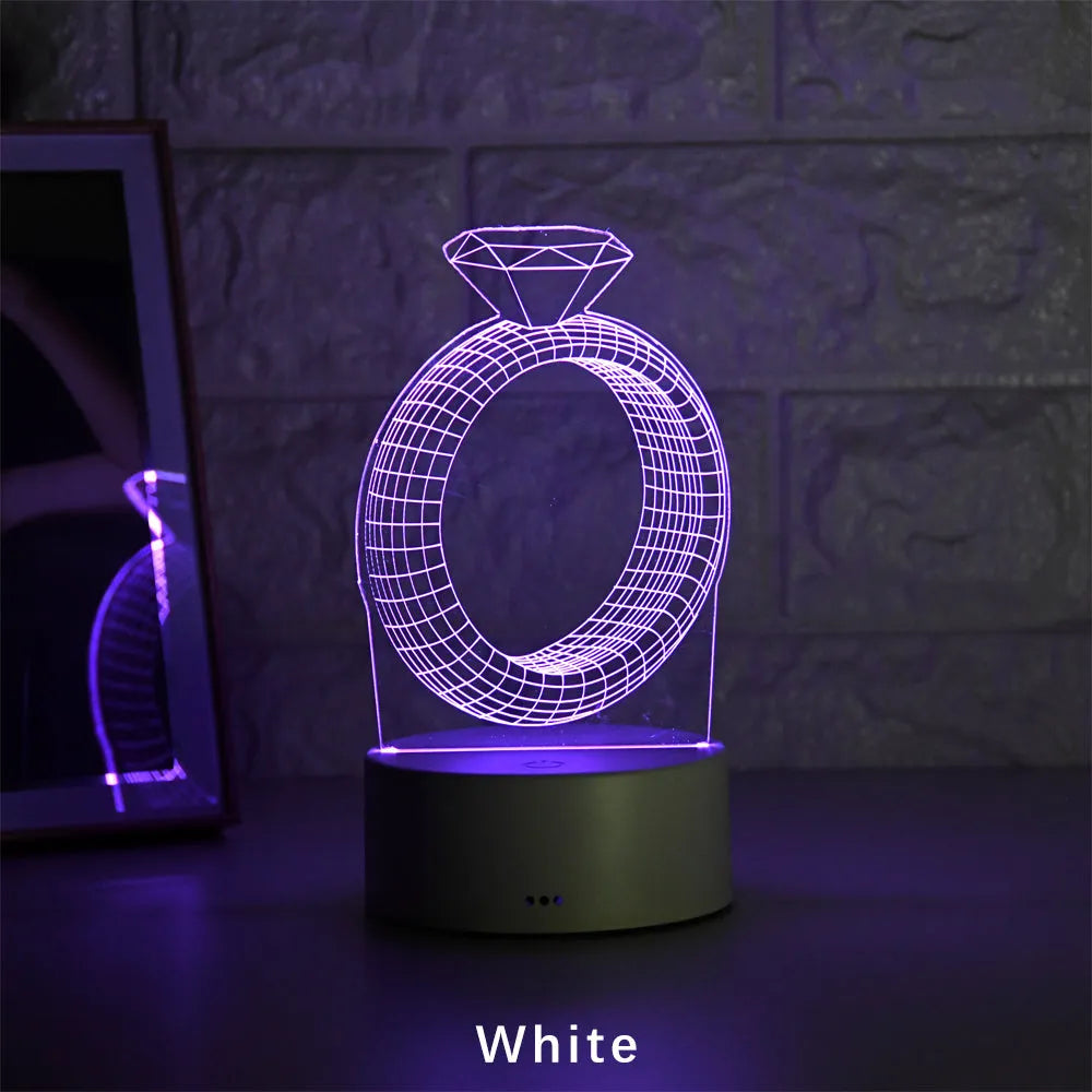 3D diamond ring design LED night light with colour-changing light on black background.