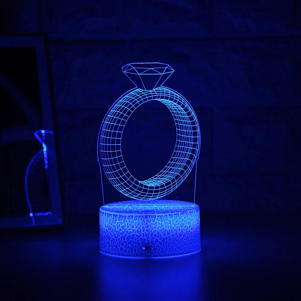 3D diamond ring design LED night light with colour-changing light on black background.