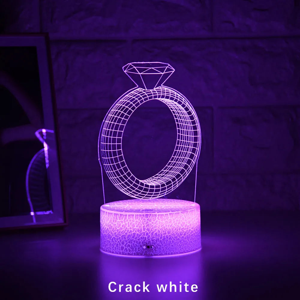 3D diamond ring design LED night light with colour-changing light on black background.