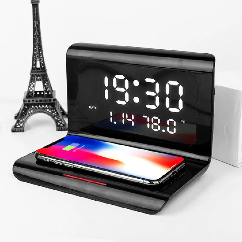 White wireless charging alarm clock showing time, date and temperature on bedside table