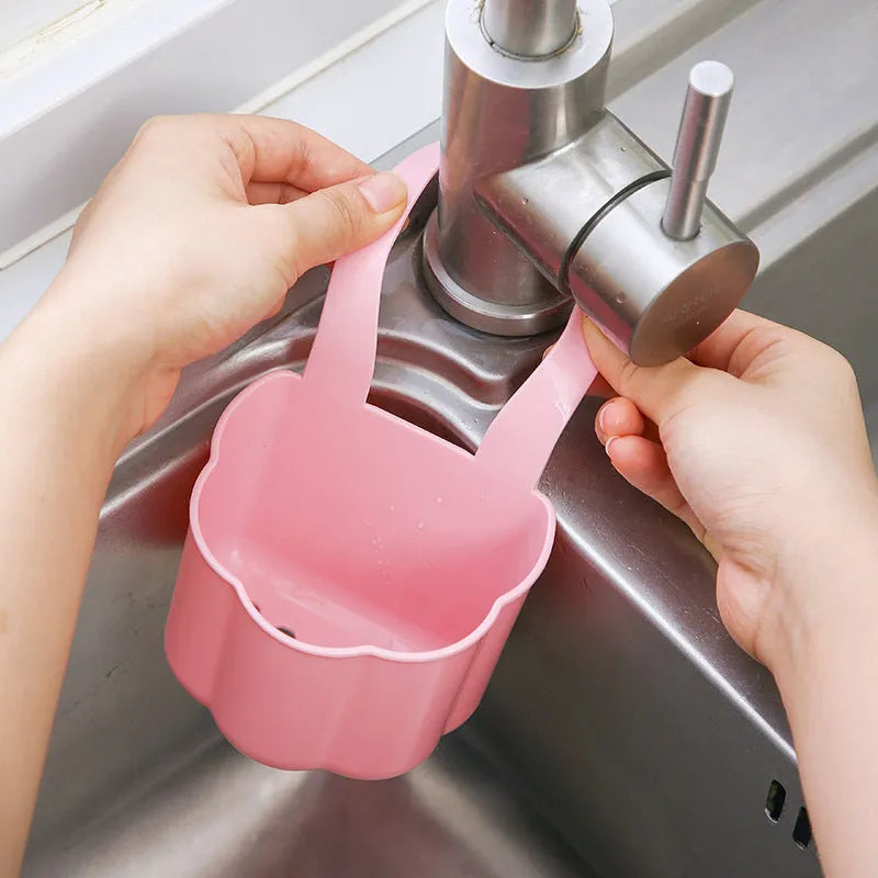 Nordic-style plastic sink drain basket in dark blue on a kitchen countertop.