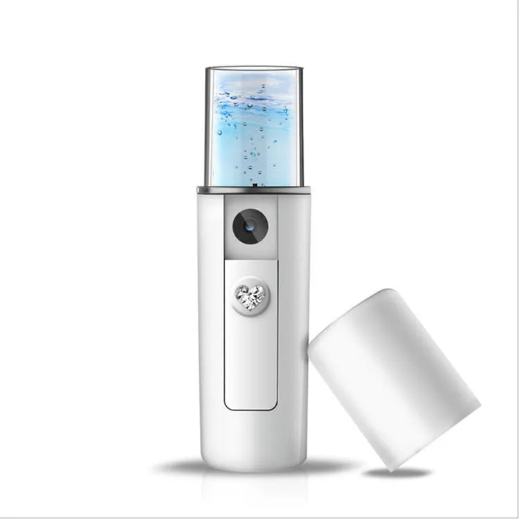 White multi-functional facial beauty instrument with LED colour light, acne needle, blackhead suction and shoveling machine attachments on table