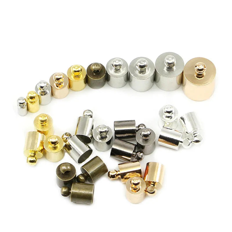 Assortment of small copper pendant weight caps in gold, silver, bronze, and black electroplated finishes.