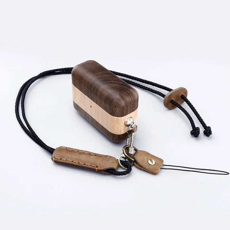 Bluetooth wireless earphones with a solid wood hard shell case and separate sleeve, compatible with Apple iPhones.