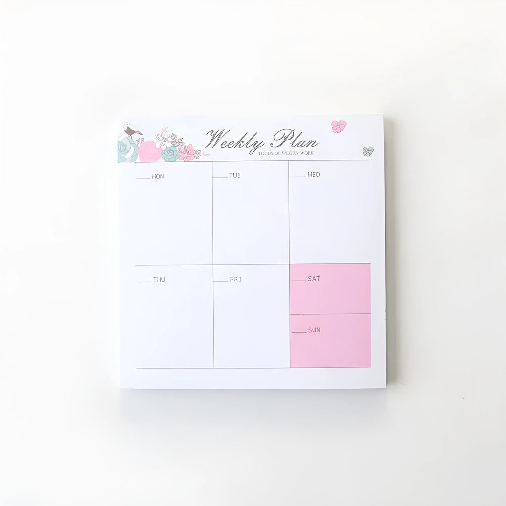Student desk organiser pad notebook with pink and green cover, open to show A4 monthly and A5 weekly planning inserts.