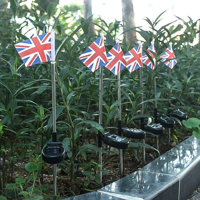 Solar garden flag light with stainless steel pole showing American flag design illuminated by white LEDs