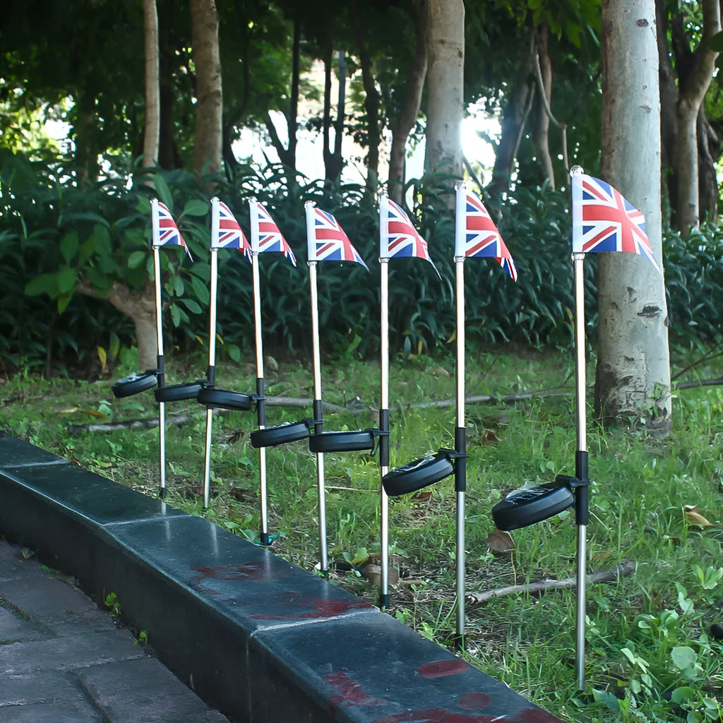 Solar garden flag light with stainless steel pole showing American flag design illuminated by white LEDs