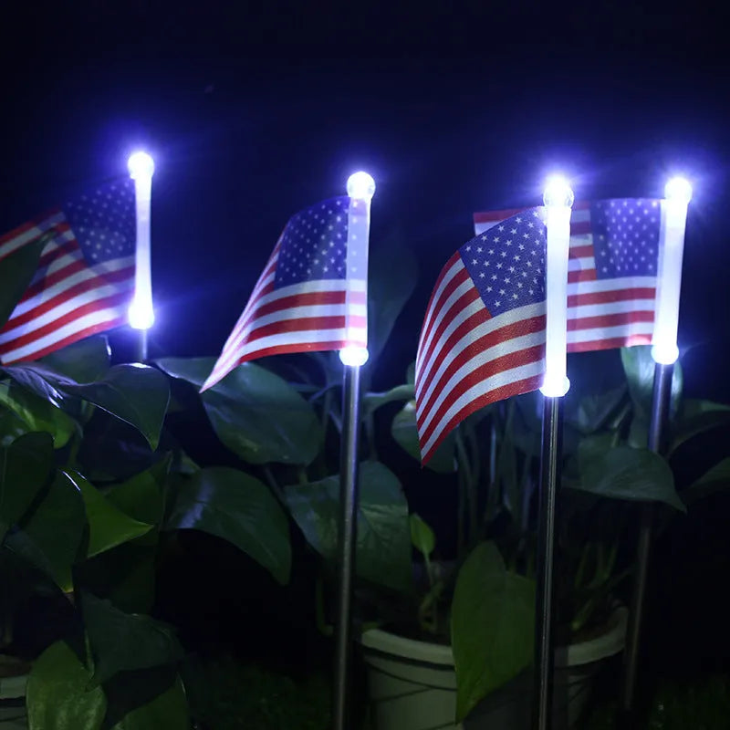 Solar garden flag light with stainless steel pole showing American flag design illuminated by white LEDs