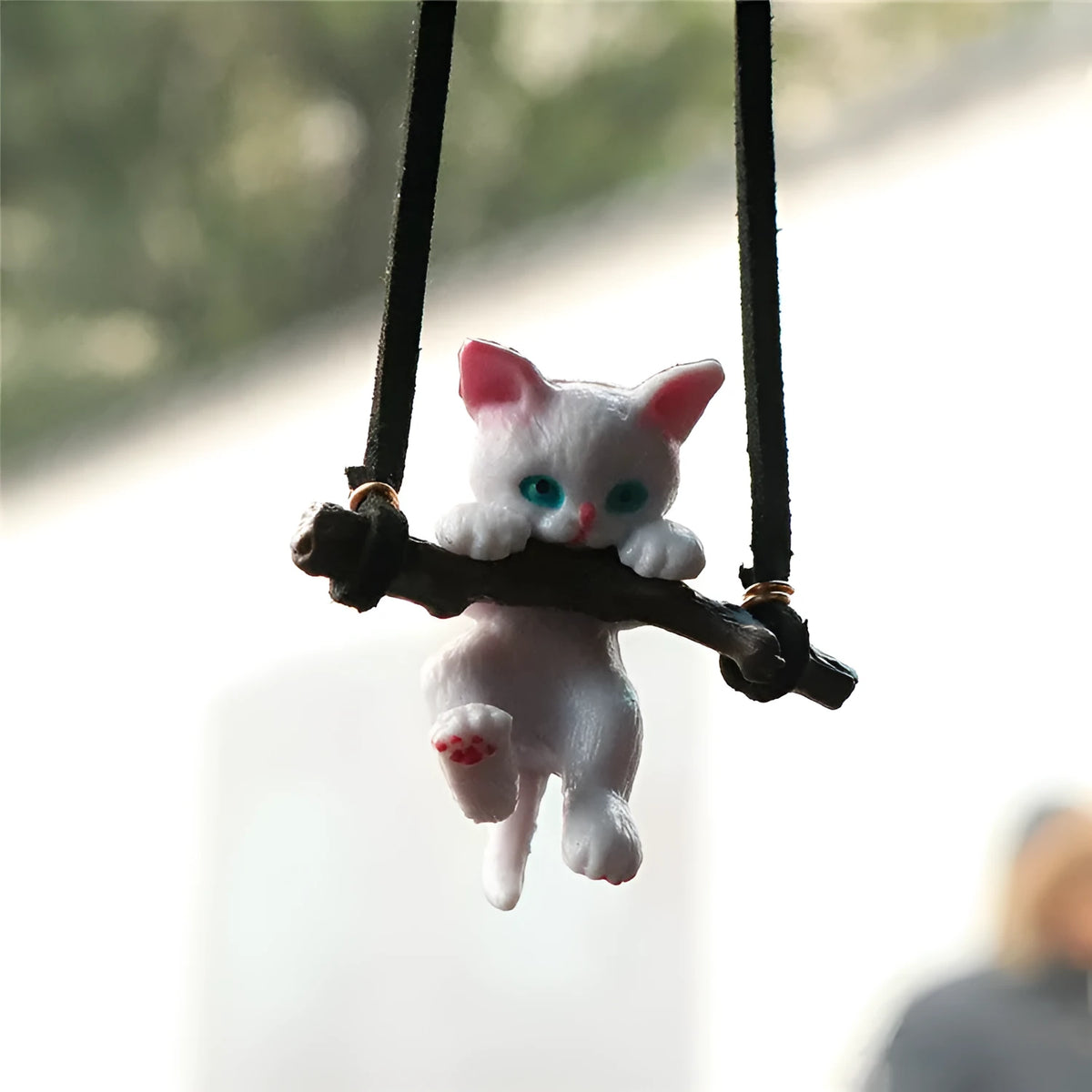 White non-woven fabric branch cat car ornament hanging from a rearview mirror with a traditional Chinese design