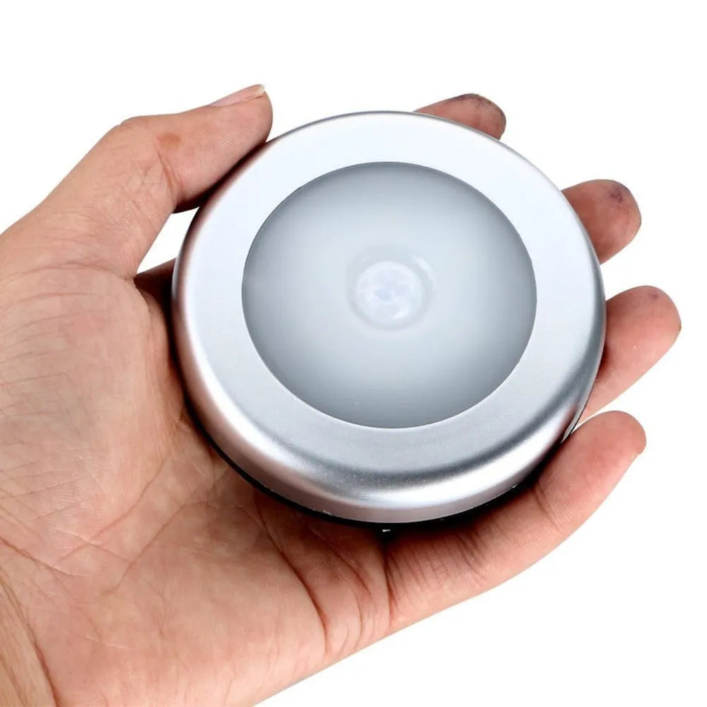 Silver wireless motion sensor night light with battery operation and white LED illumination