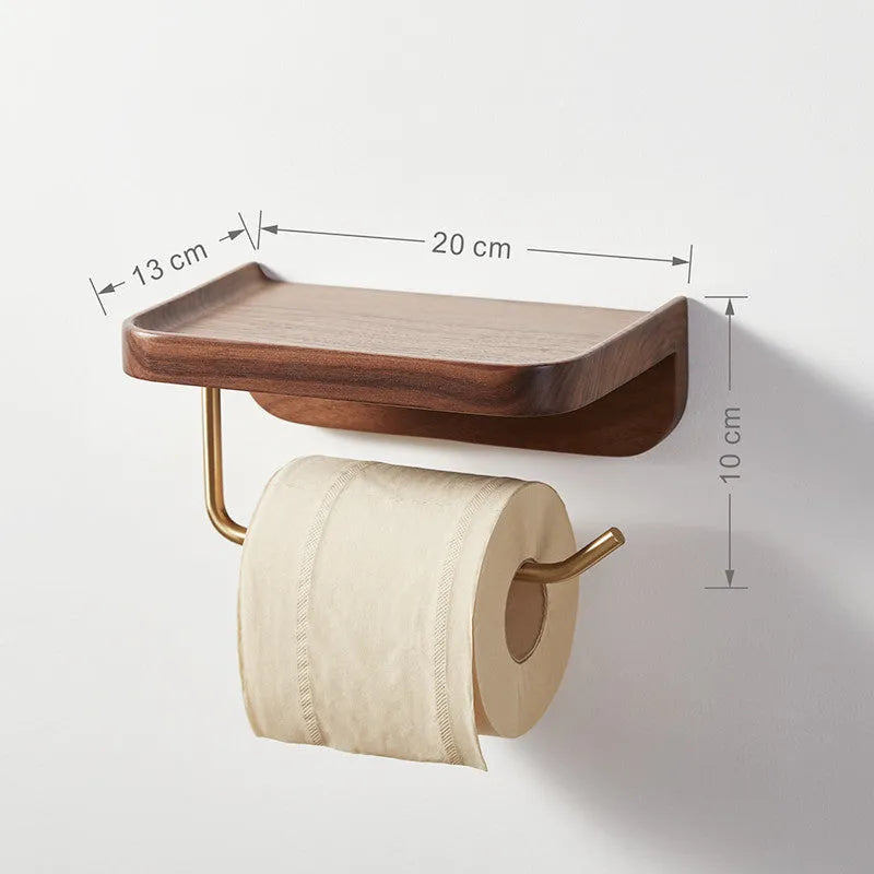 Solid walnut wood wall-mounted paper towel holder with brass fittings on a white wall.