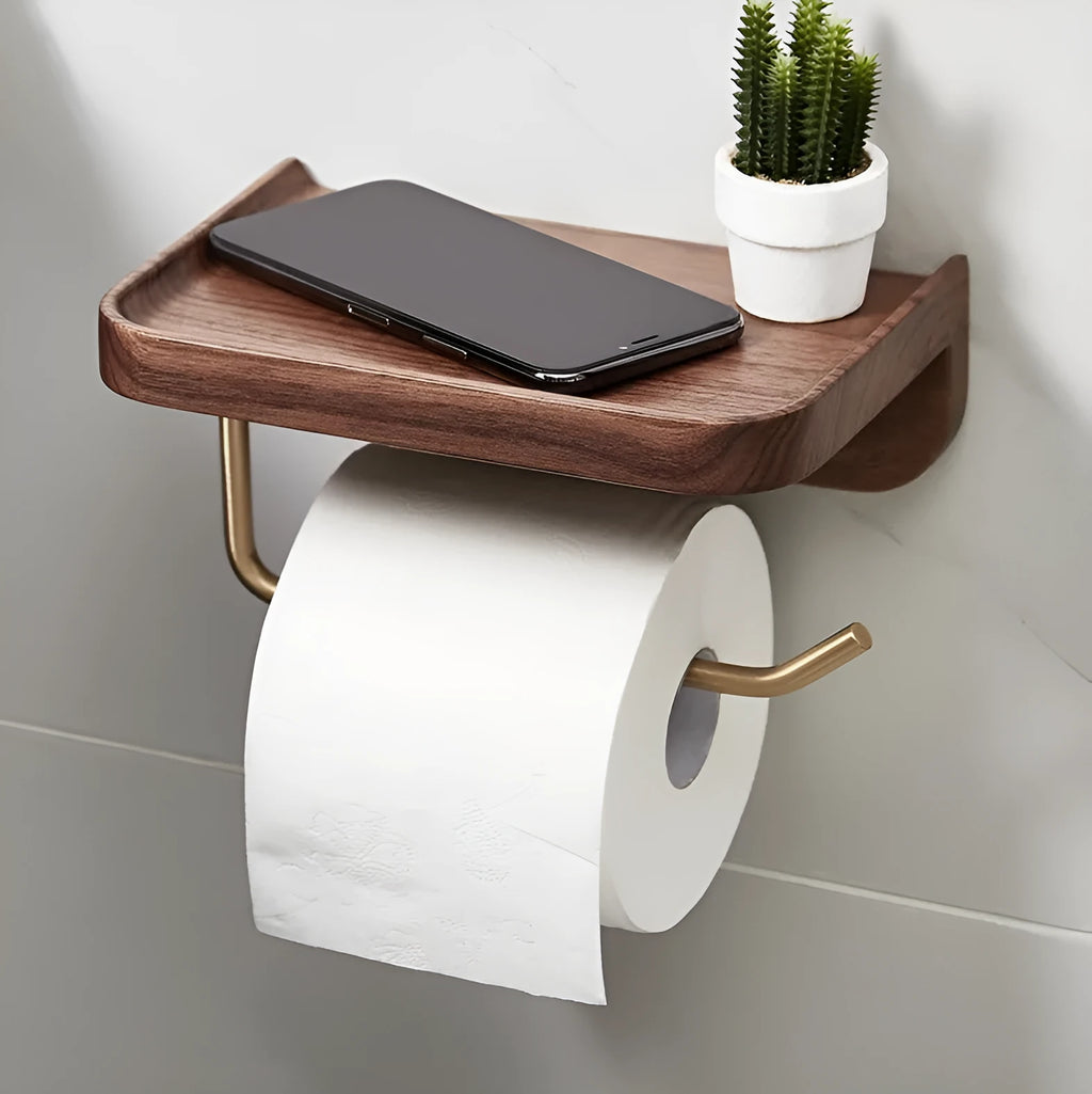 Solid walnut wood wall-mounted paper towel holder with brass fittings on a white wall.