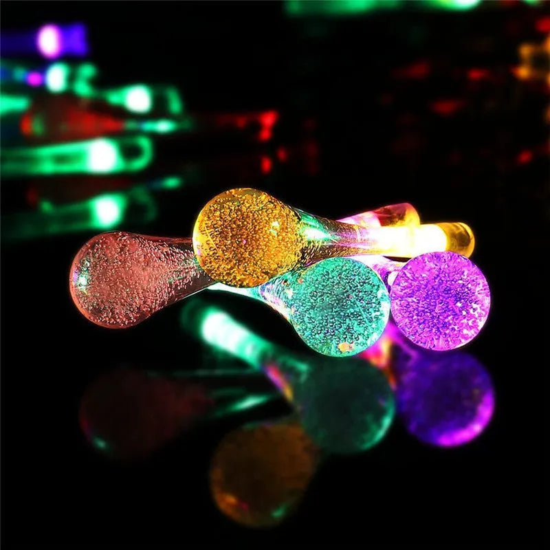 Solar-powered outdoor string lights with water drop shaped pendants on a 6.5 metre cable.