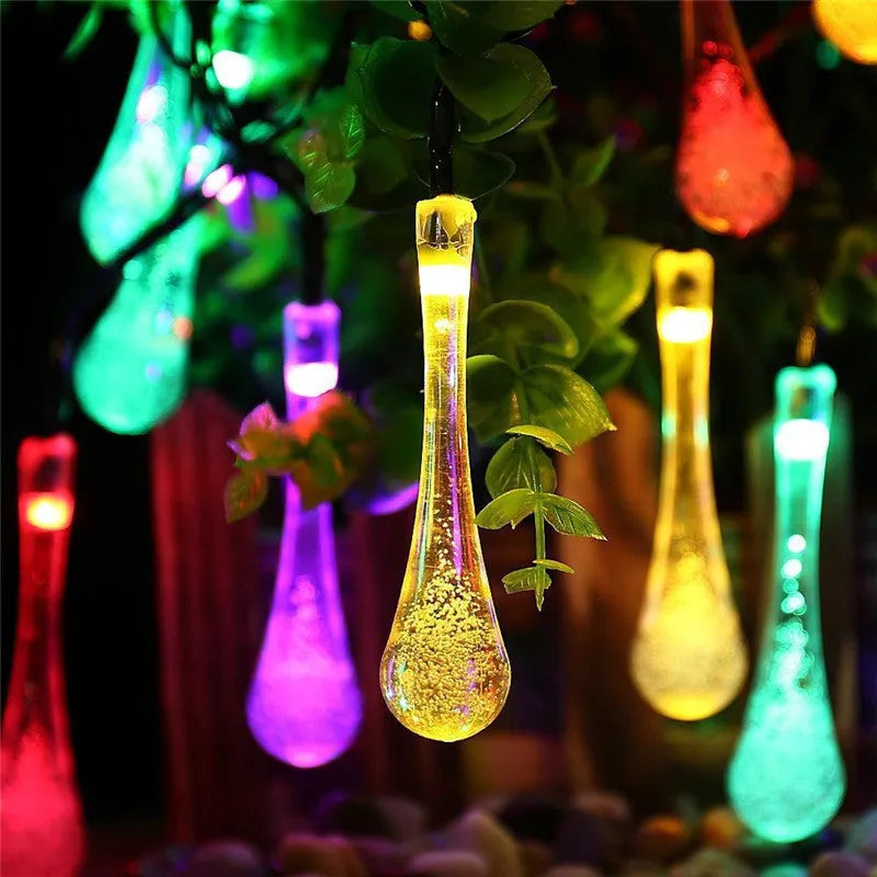 Solar-powered outdoor string lights with water drop shaped pendants on a 6.5 metre cable.