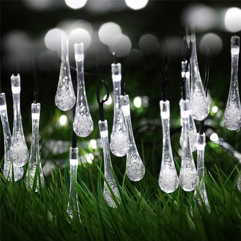 Solar-powered outdoor string lights with water drop shaped pendants on a 6.5 metre cable.