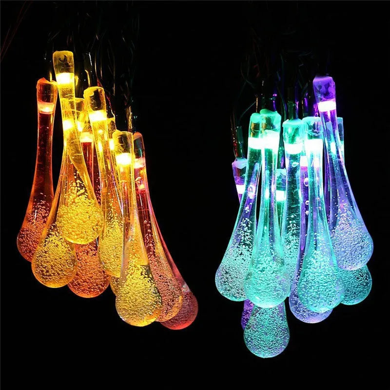 Solar-powered outdoor string lights with water drop shaped pendants on a 6.5 metre cable.