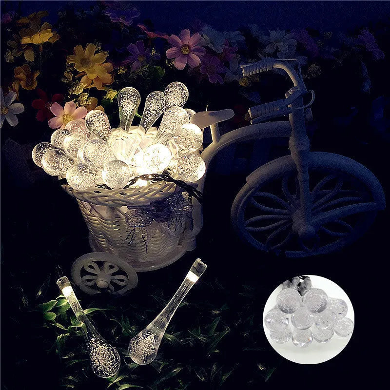 6.5 metre solar LED string lights with bubble drops pendants decorating an outdoor fence