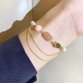 Women's freshwater pearl bracelet with geometric design and strawberry crystal charm in pink