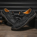 Men's plain black microfibre leather casual slip-on shoes with round toe on a white background.