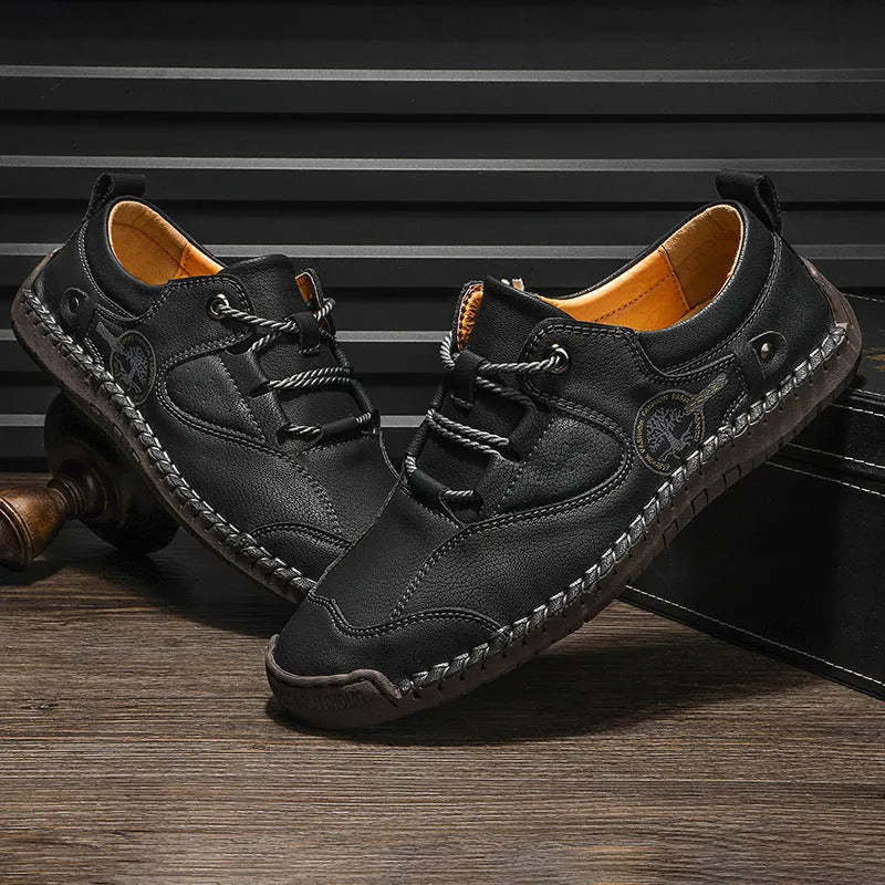 Men's plain black microfibre leather casual slip-on shoes with round toe on a white background.