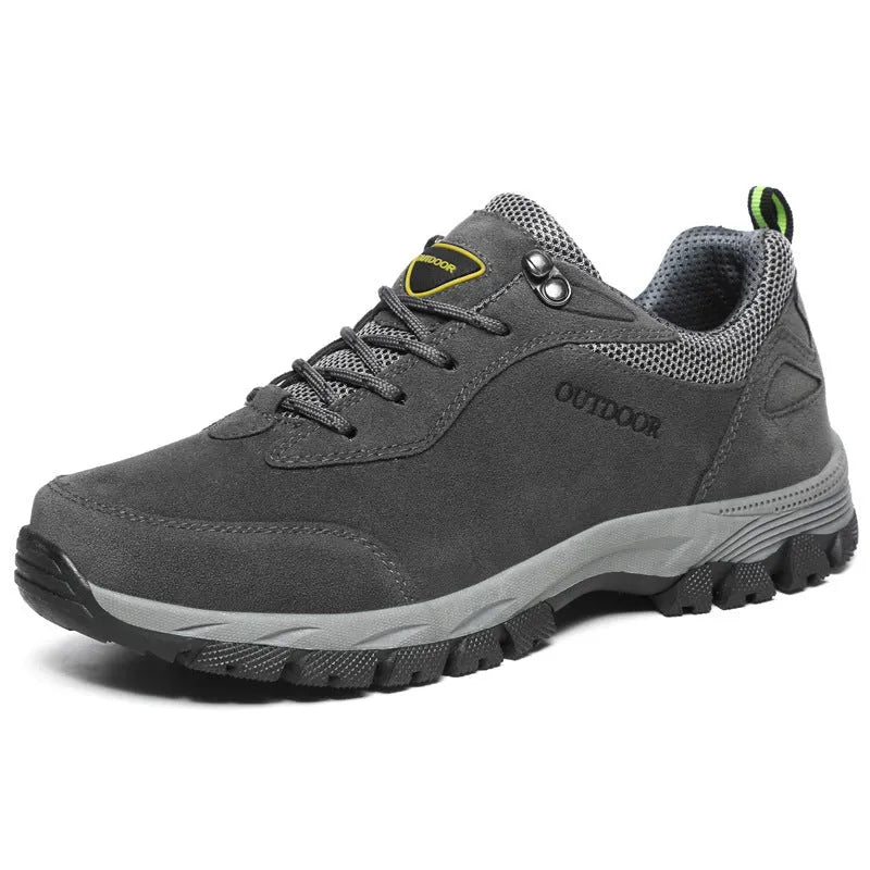 Men's low-top hiking shoe in army green with mesh upper on a natural surface